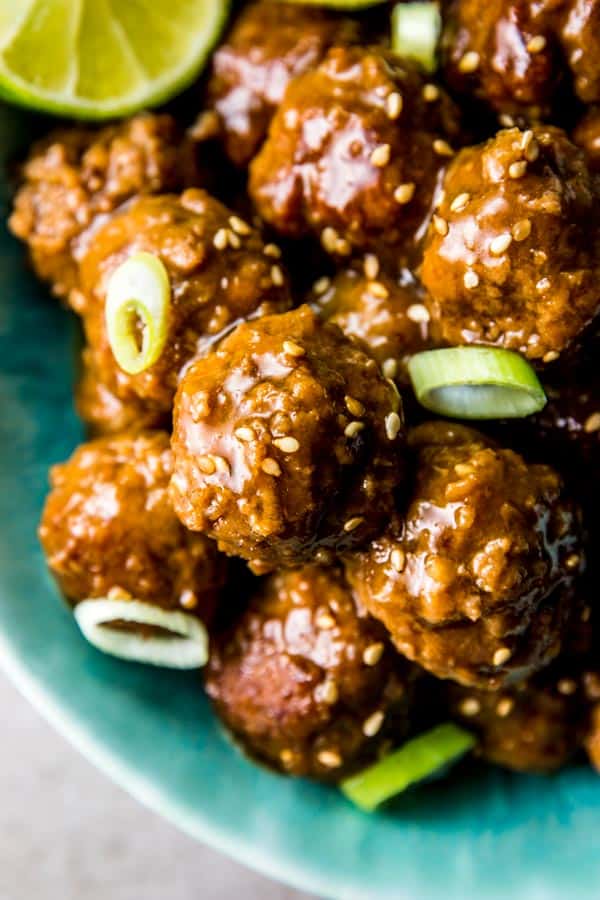 close up of honey garlic meatballs in blue bowl