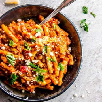 overhead view on Italian sausage pasta in black dish