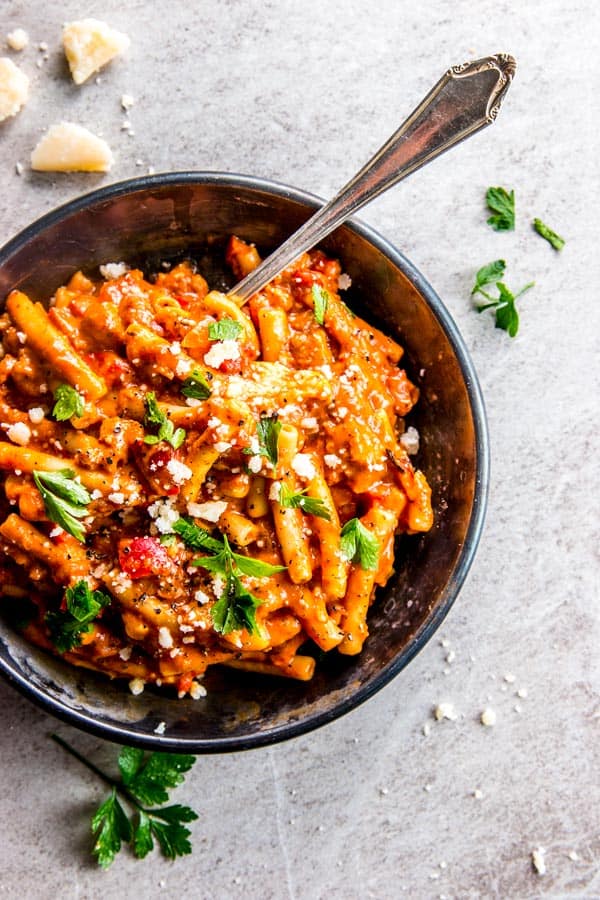 overhead view on Italian sausage pasta in black dish