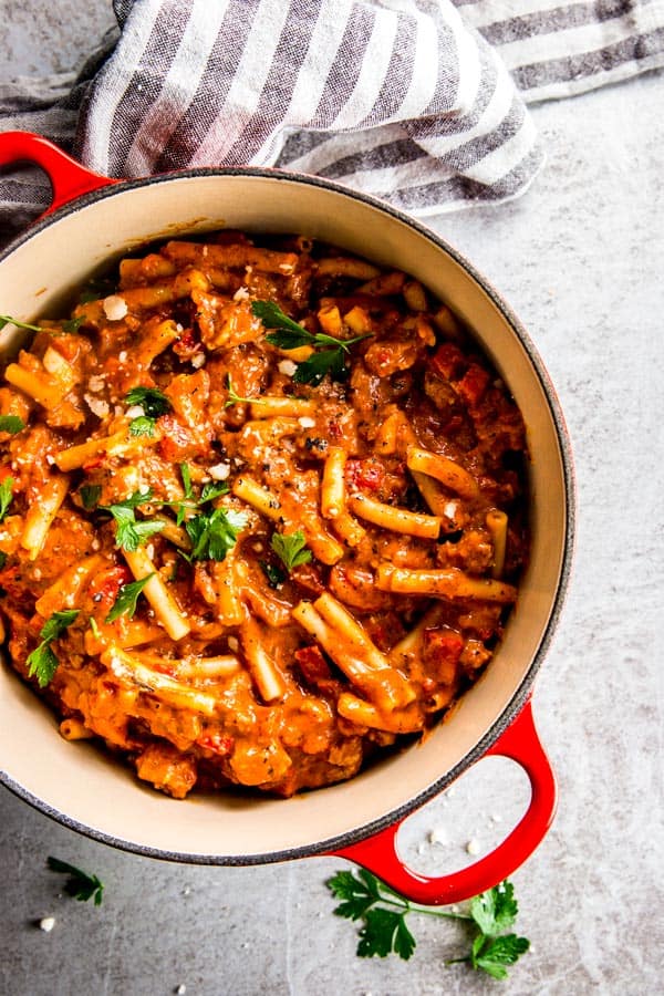 overhead view of red cast iron pot with one pot ziti