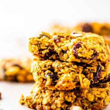 stack of three pumpkin breakfast cookies, top one with bite taken out