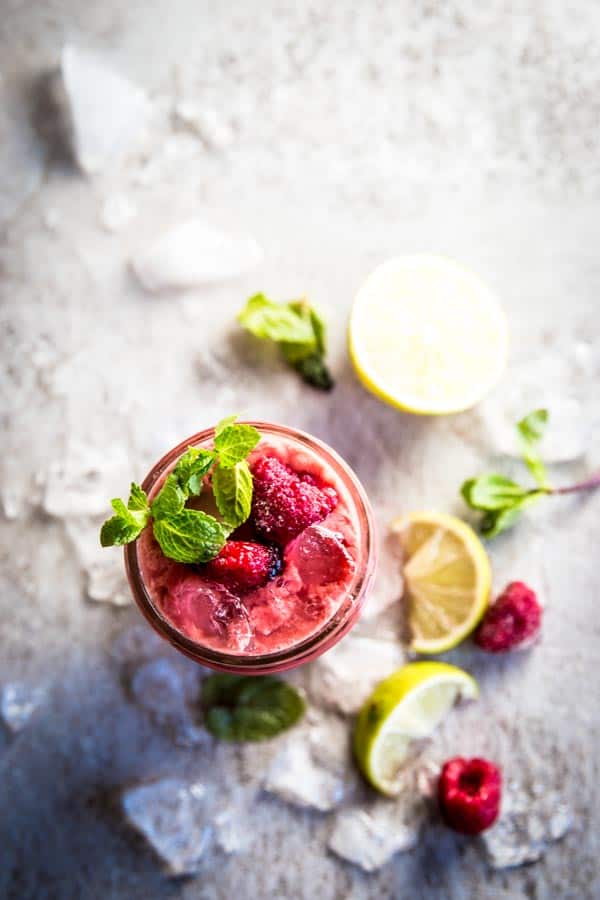 overhead view on jam jar with raspberry mango smoothie