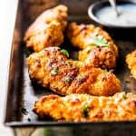 This Garlic Parmesan Crispy Oven Fried Chicken is the only recipe you'll need for crunchy baked chicken! The BEST golden breading that actually sticks to the chicken and great intense flavor - better than KFC!