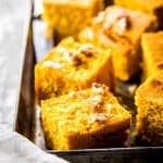 sliced pumpkin cornbread on metal tray