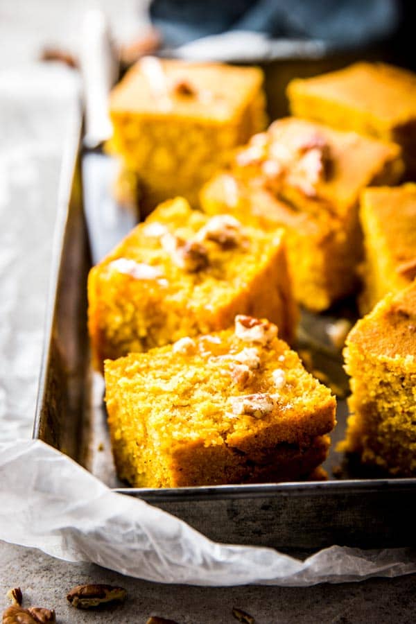 sliced pumpkin cornbread on metal tray