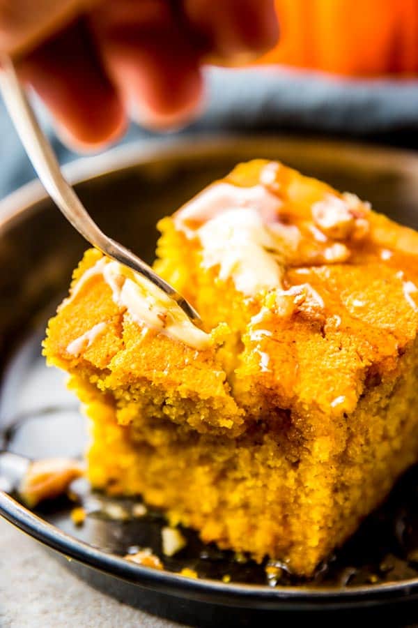 fork digging in slice of pumpkin cornbread