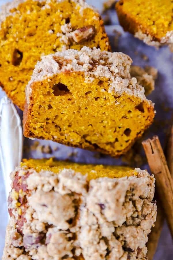 slices of streusel pumpkin bread stacked on a board