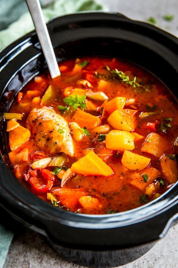 Tuscan White Bean Crockpot Chicken Stew in black crock