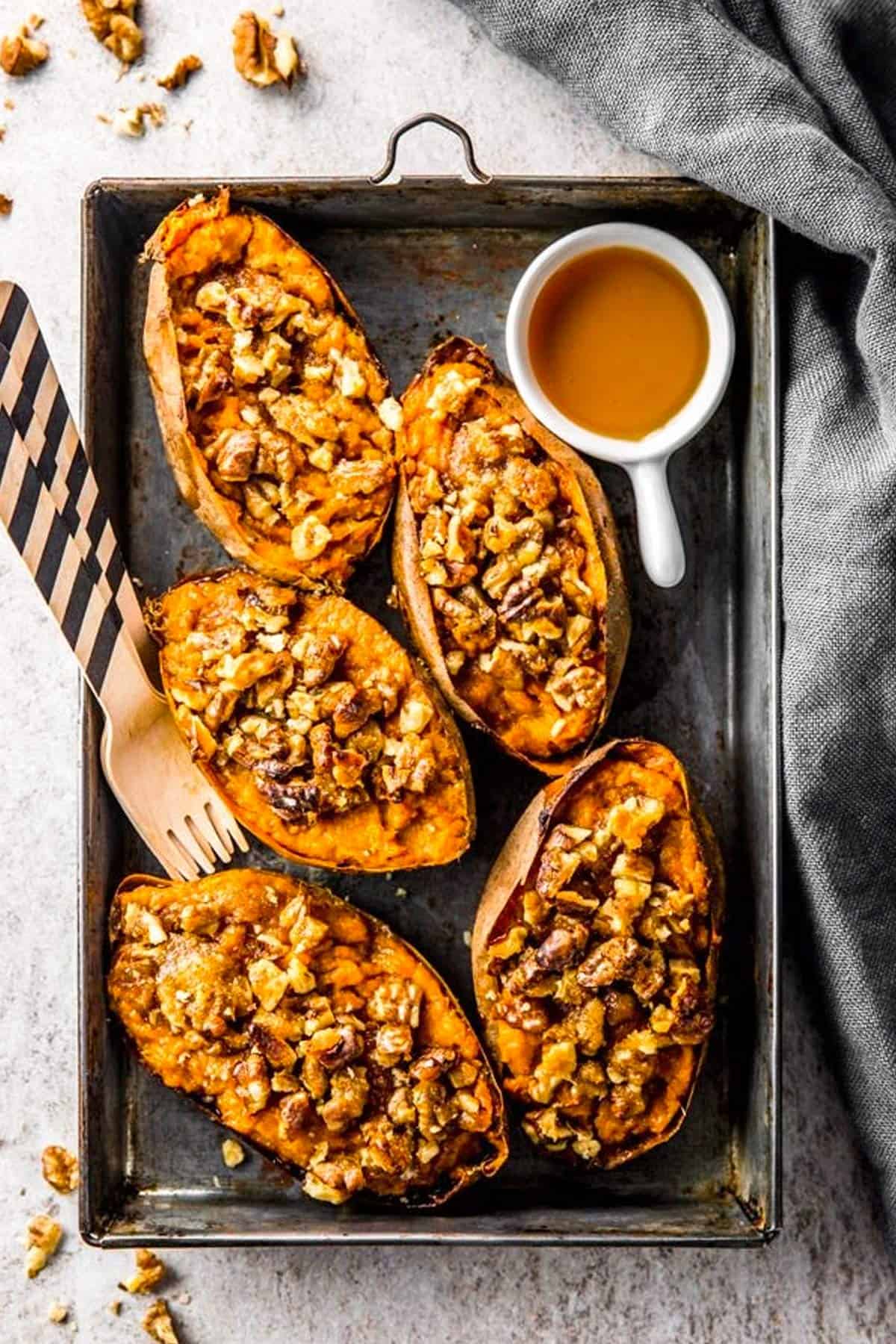 overhead view of black aluminum pan with twice baked sweet potato skins