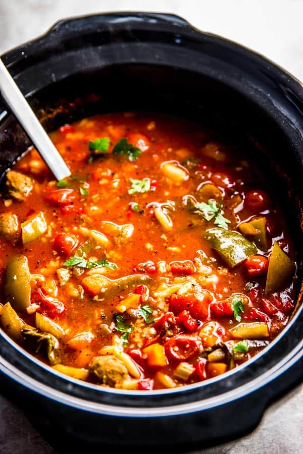 black crock pot filled with slow cooker tuscan white bean and sausage soup