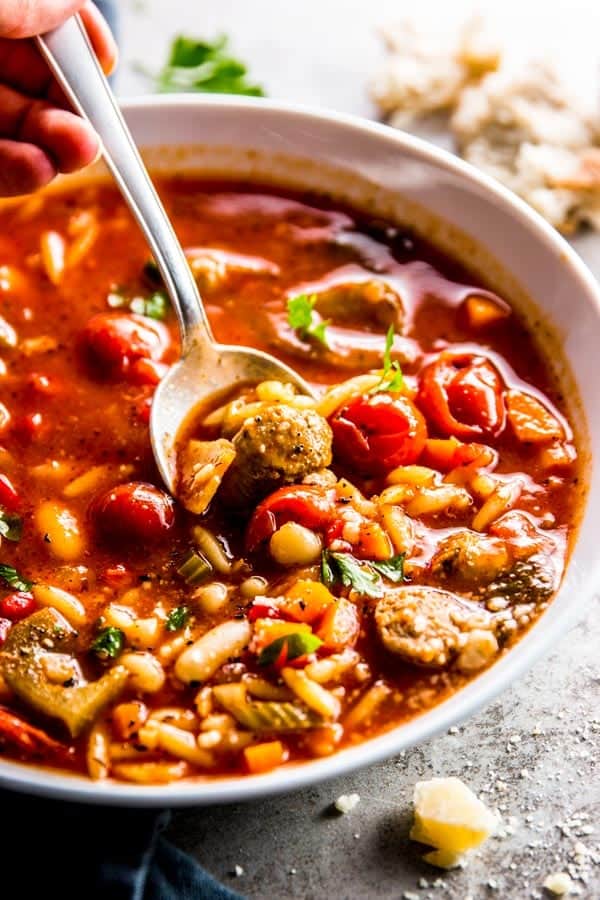 close up photo of crockpot soup with sausage and white beans