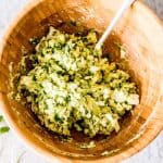 overhead view of wooden bowl filled with avocado egg salad