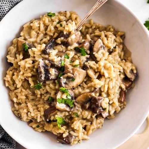 close up of white plate with mushroom risotto
