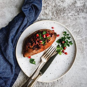 lentil stuffed sweet potato on white plate