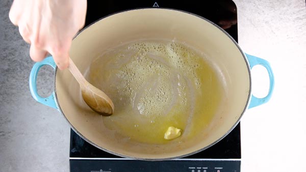 Melting butter in a Dutch oven.
