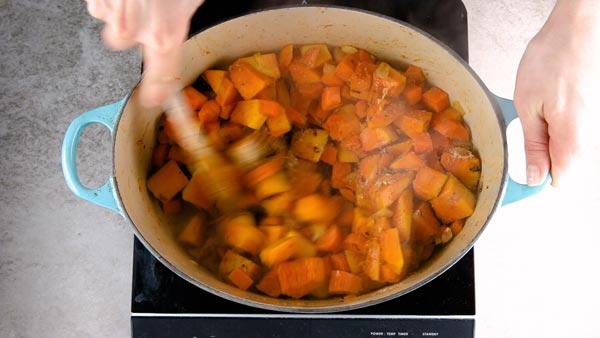 Roasting the vegetables and spices for easy pumpkin soup.