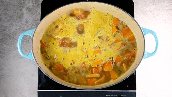 Pot of easy pumpkin soup simmering on the stove.