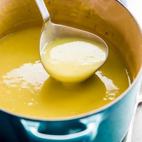 ladling potato leek soup out of blue Dutch oven