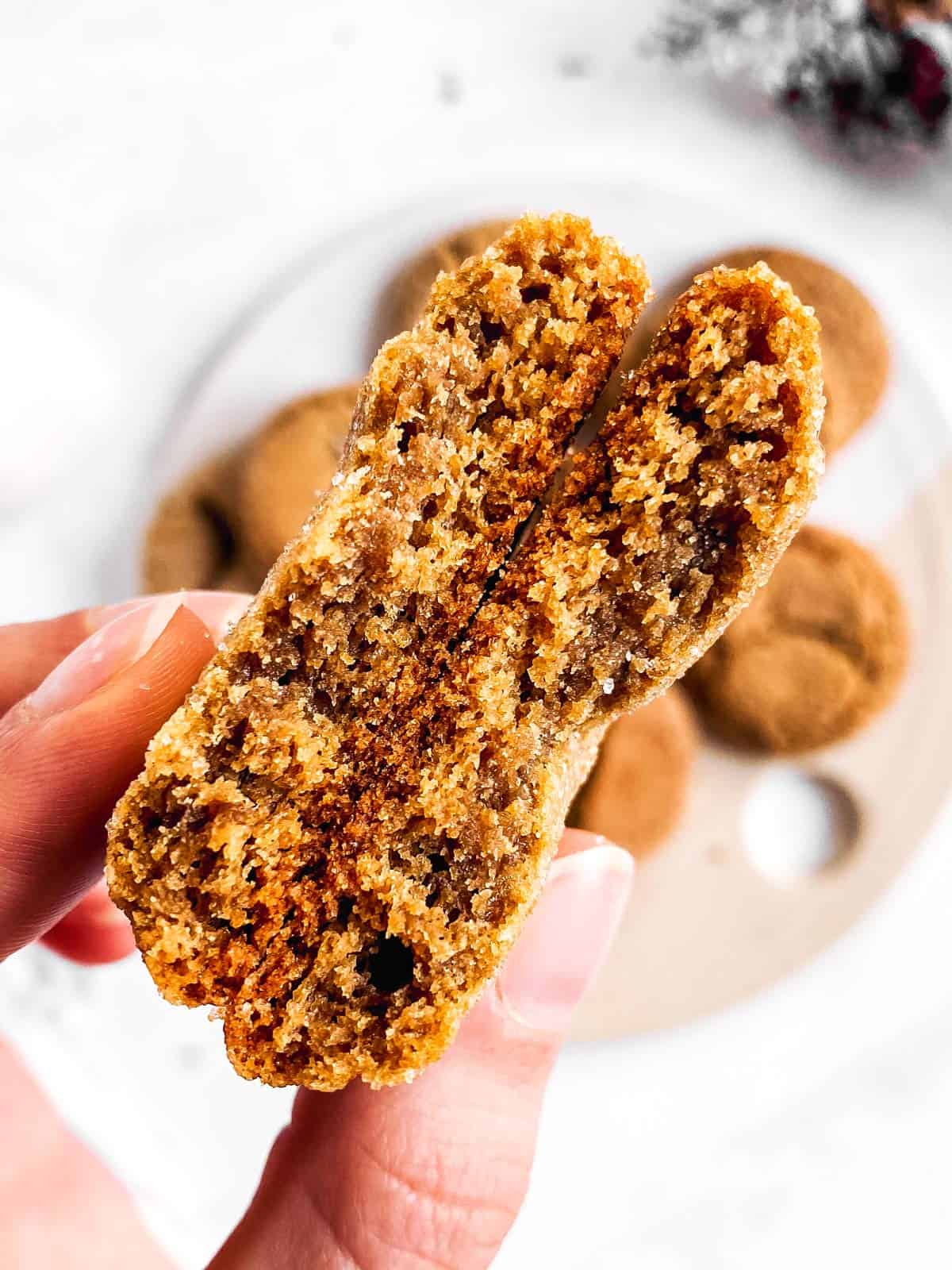 halved molasses cookie in female hands