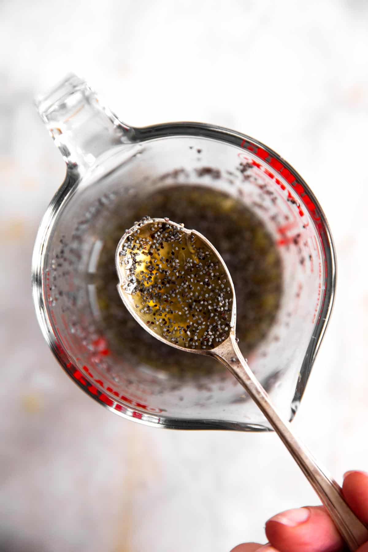 overhead view of poppy seed fruit salad dressing on a spoon