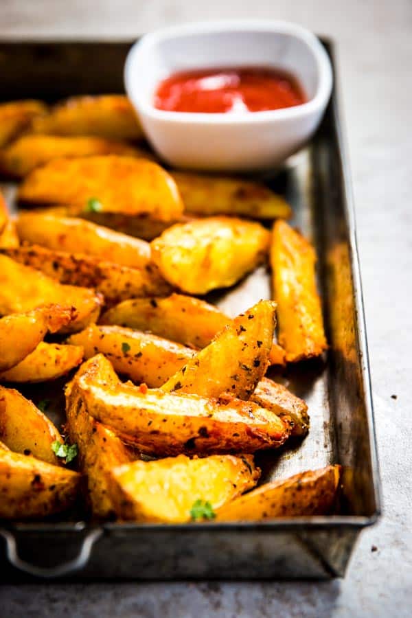 Baked potato wedges on a baking tray