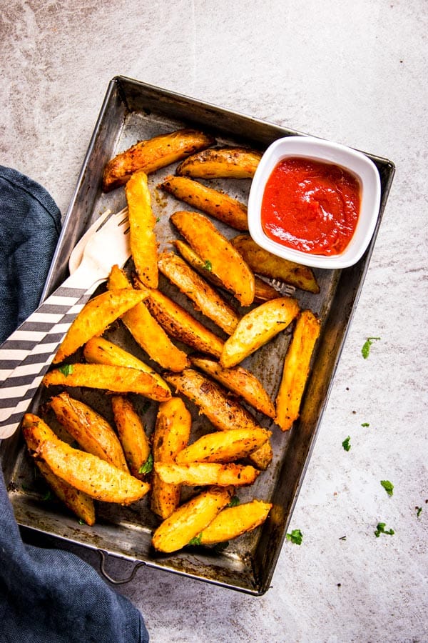 Baked potato wedges on a baking tray