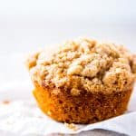 Banana Crumb Muffin on a sheet of parchment paper.