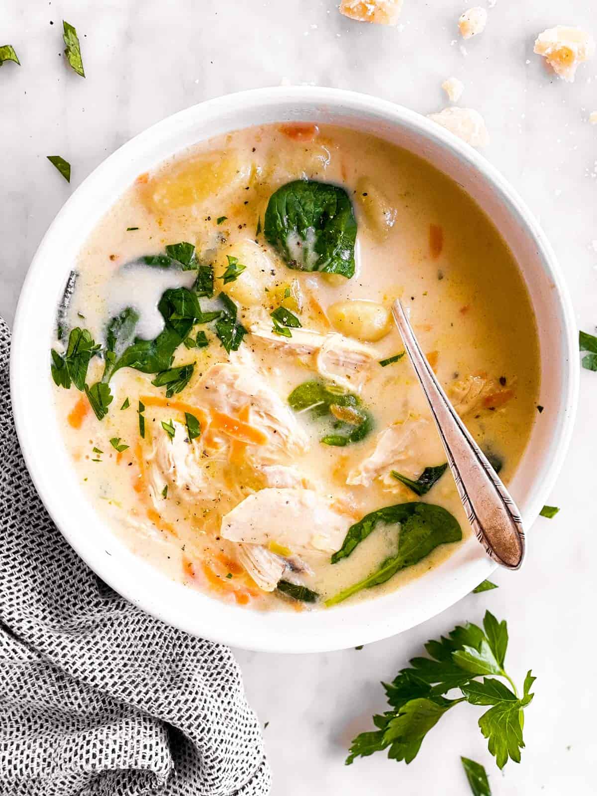 overhead photo of white bowl filled with chicken gnocchi soup