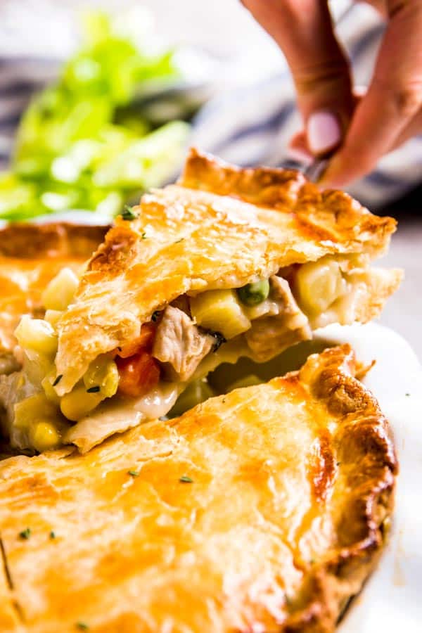 Lifting out a slice of homemade chicken pot pie.