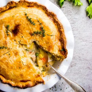 Homemade chicken pot pie with the first slice taken out.