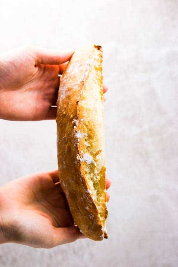 Holding a homemade French bread.