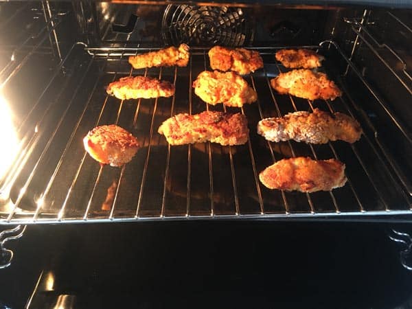 Leftover fried chicken reheating in the oven.