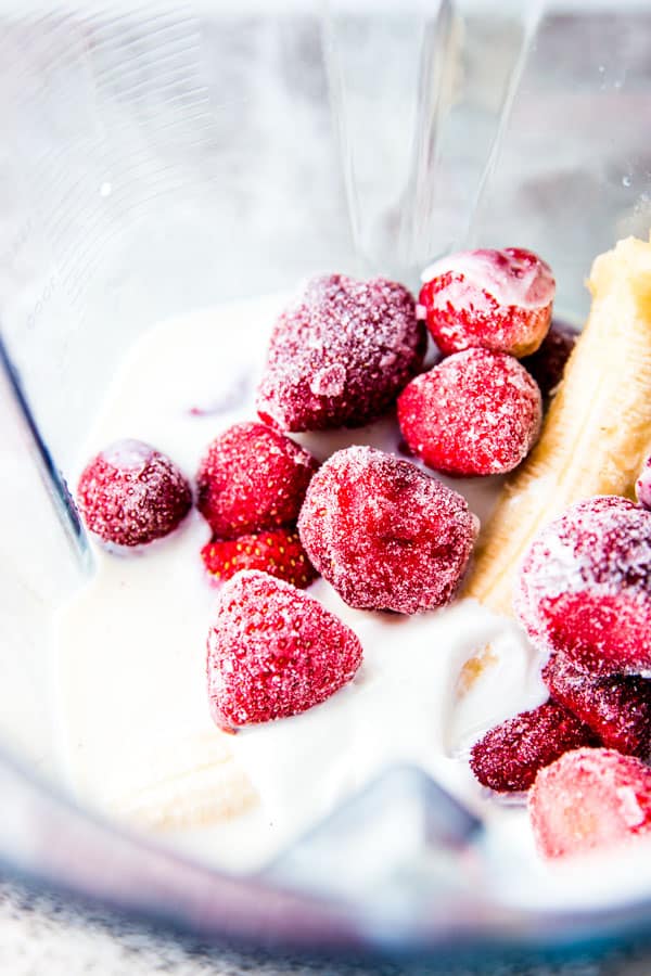 Ingredients for Strawberry Banana Smoothie in a blender.