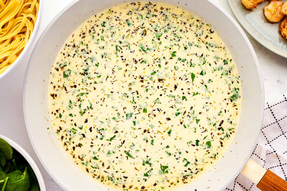 Finishing shrimp sauce with cream.