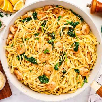 Skillet with garlic butter shrimp pasta.