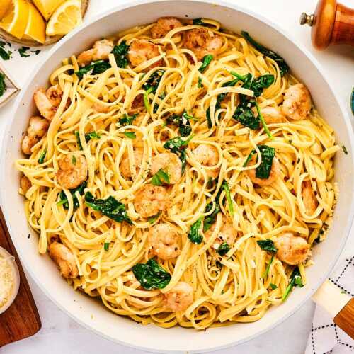 Skillet with garlic butter shrimp pasta.