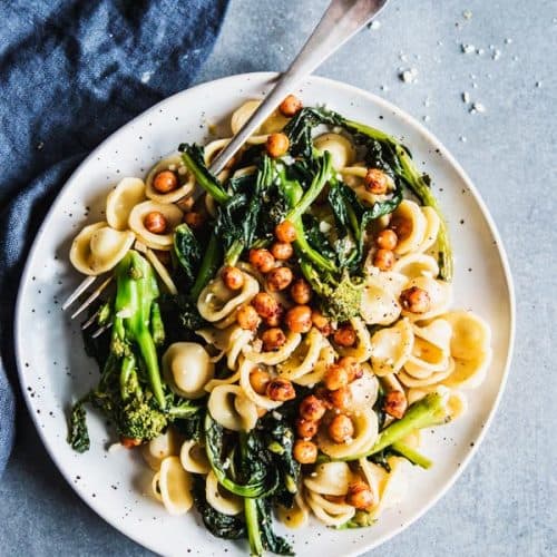 Broccoli Rabe Pasta on a white plate with a black napkin.