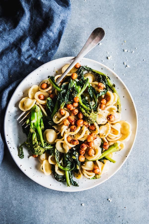 Broccoli Rabe Pasta on a white plate with a black napkin.