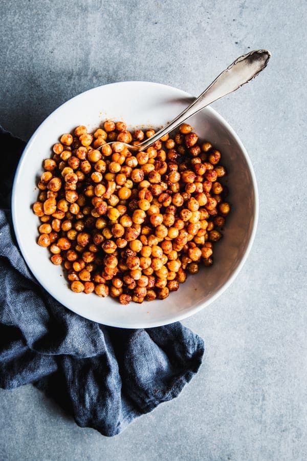 Smoked paprika roasted chickpeas in a white soup plate.