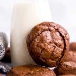 brownie cookie leaning against a bottle of milk