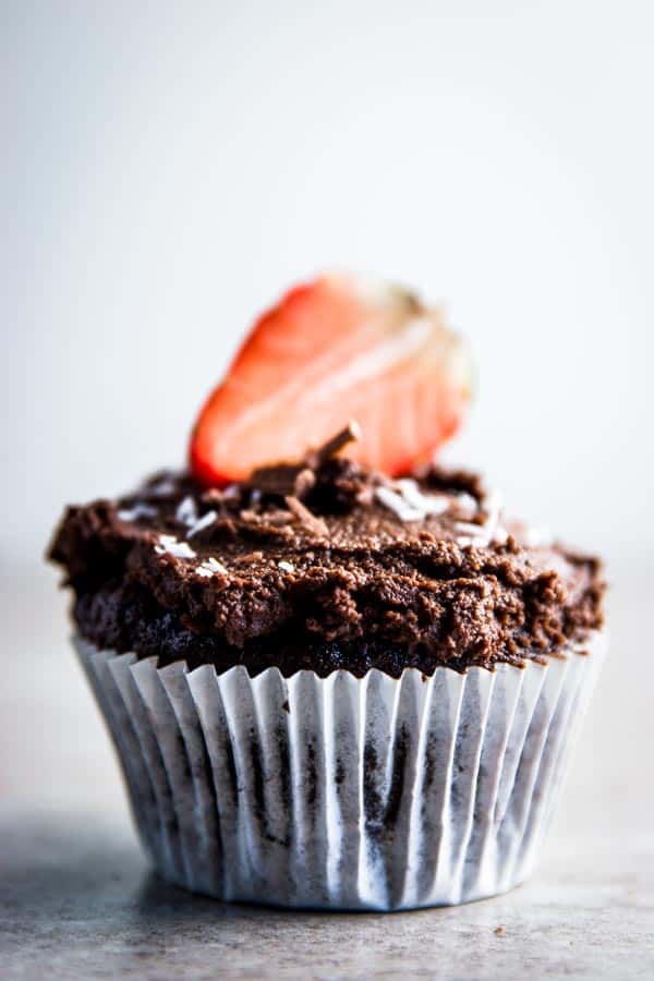Easy chocolate cupcake with chocolate frosting and strawberry on top.