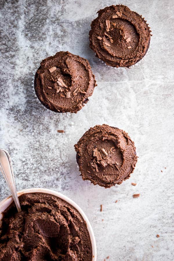 Three chocolate cupcakes, just spread with easy chocolate frosting.