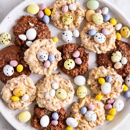 overhead view of white plate with bird's nest cookies and mini eggs