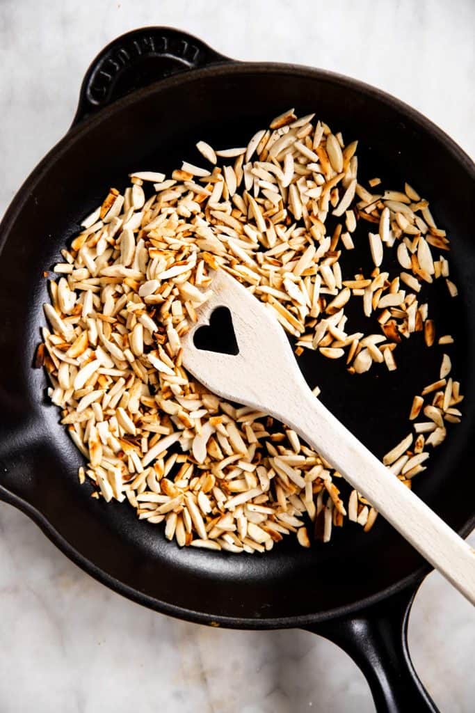 toasted almonds in black cast iron skillet