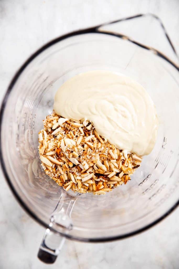 melted white chocolate and toasted nuts in glass bowl 