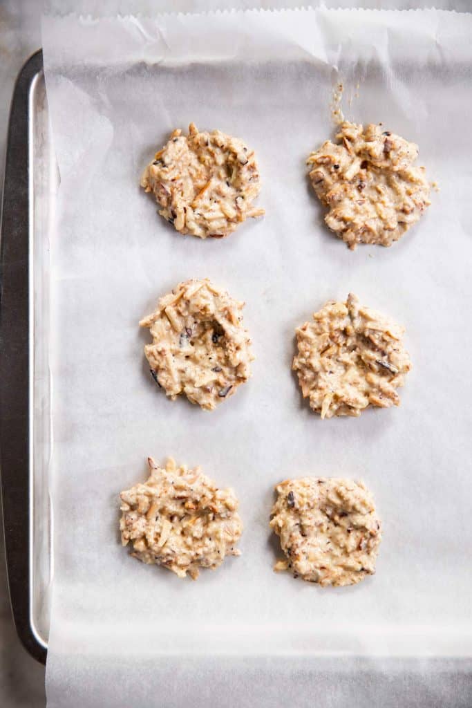 six shaped bird's nest cookies on pan lined with white baking parchment