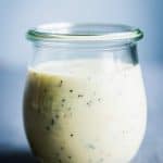 Creamy poppy seed fruit salad dressing in a small weck jar.