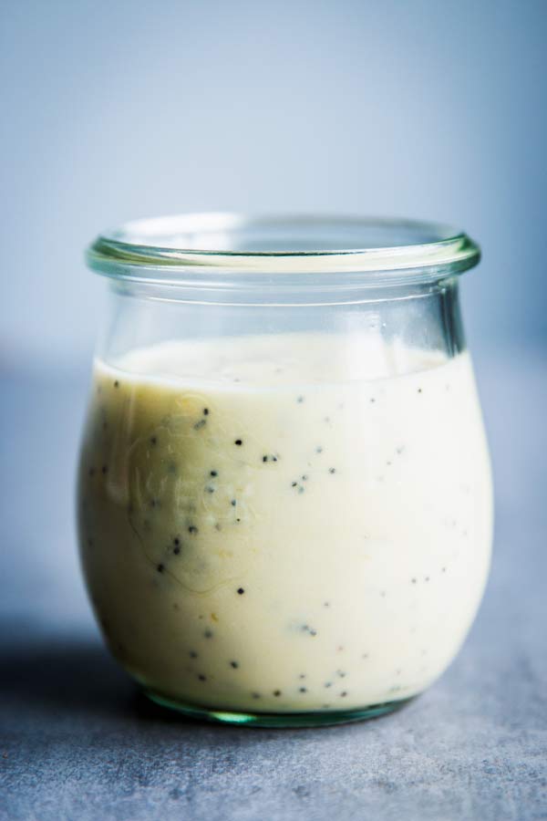 Creamy poppy seed fruit salad dressing in a small weck jar.