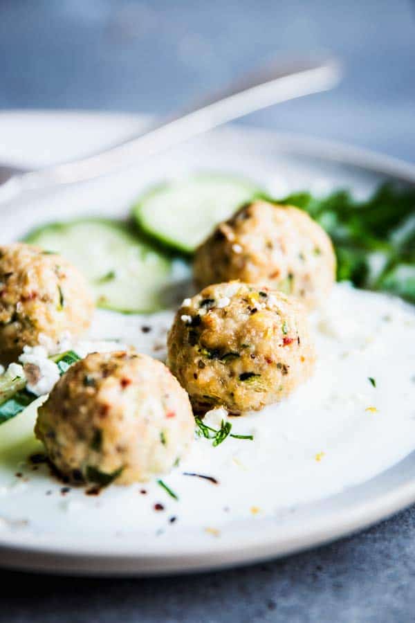 Close up photo of Greek Turkey Meatballs on a white plate.