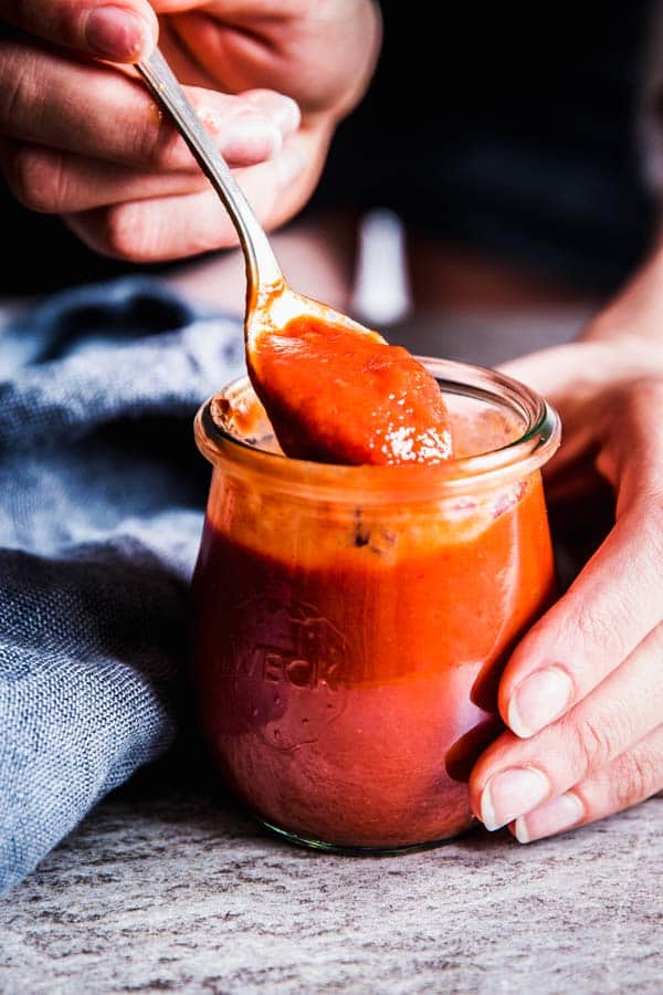 spooning meatloaf sauce out of a jar